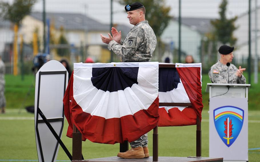 Incoming U.S. Army Europe commander Lt. Gen. Frederick ''Ben'' Hodges, foreground, and the outgoing commander, Lt. Gen. Donald Campbell Jr., applaud USAREUR troops at the unit's change-of-command ceremony in Wiesbaden, Germany, Wednesday, Nov. 5, 2014.