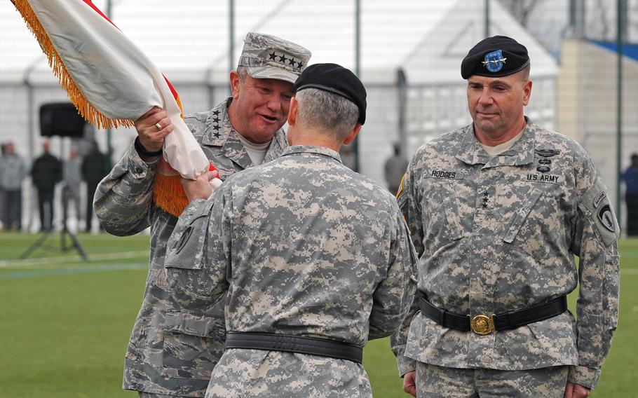 The commander of U.S. European Command, Gen. Philip Breedlove takes the USAREUR colors from its outgoing commander, Lt. Gen. Donald Campbell Jr., as the incoming commander, Lt. Gen. Frederick ''Ben'' Hodges, right, watches at the change-of-command ceremony in Wiesbaden, Germany, Wednesday, Nov. 5, 2014.