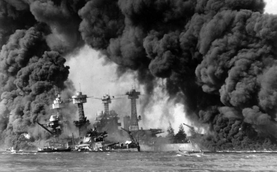 The USS West Virginia, sunken at left, and USS Tennessee are shrouded in smoke Dec. 7, 1941, following the Japanese attack on Pearl Harbor, Hawaii.