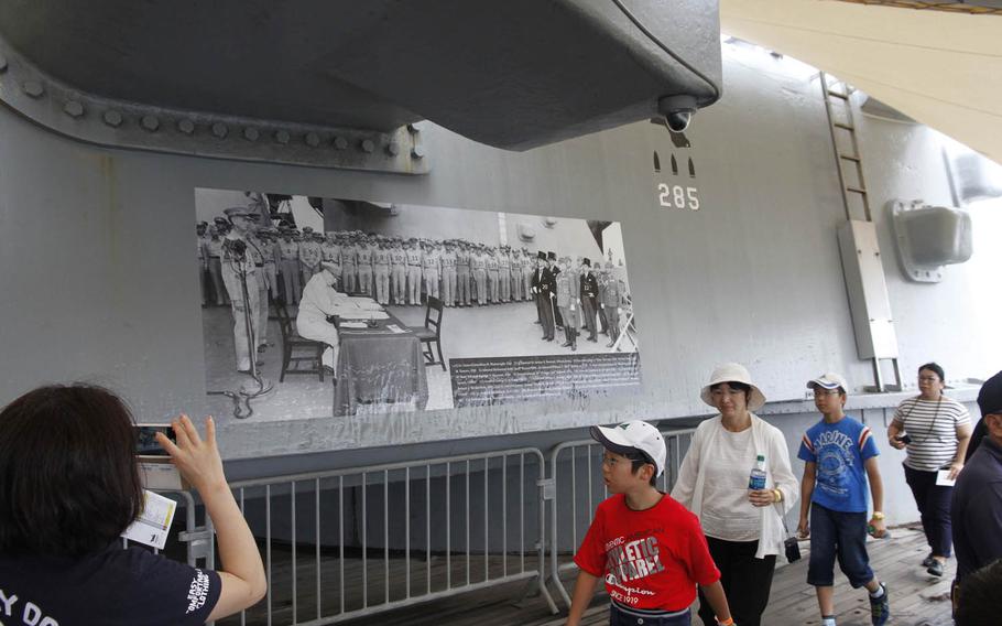 A large photo on the main deck of the Missouri Battleship Memorial in Hawaii shows Gen. Douglas MacArthur and Japanese officials signing the formal surrender documents aboard the ship on Sept. 2, 1945.