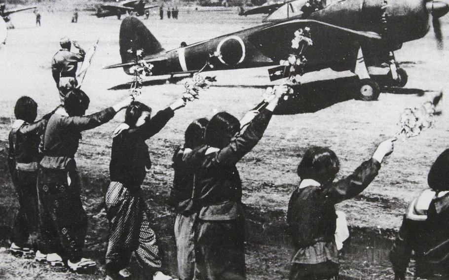 Japanese high school students wave cherry blossoms as a kamikaze pilot prepares for his sortie on April 12, 1945, in this photo displayed in the below-deck museum at the Missouri Battleship Memorial in Pearl Harbor, Hawaii.