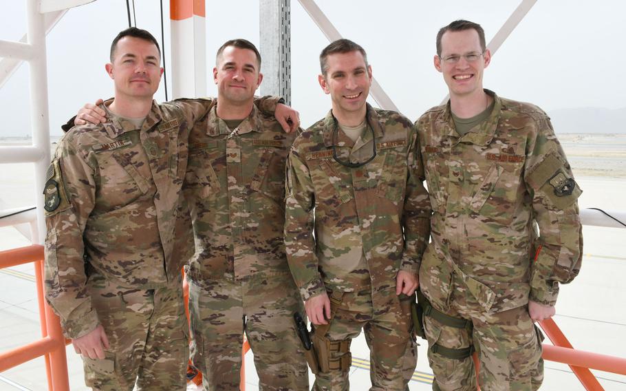 Members of the 451st Expeditionary Operations Support Squadron's meteorological team pose for a photo on their observation deck at Kandahar Air Field, Afghanistan, on March 19, 2018. Pictured are from left are Air Force Master Sgt. Dominick Martin, Tech. Sgt. Michael Theos, Maj. William Henning and Staff Sgt. Timothey Everhard.