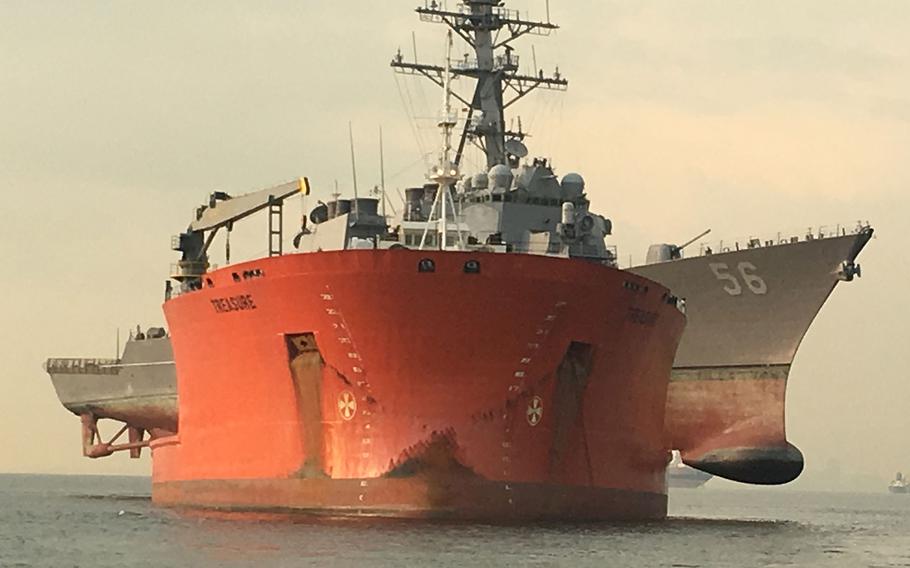 The USS John S. McCain is loaded onto the heavy lift transport MV Treasure, Oct. 7, 2017.