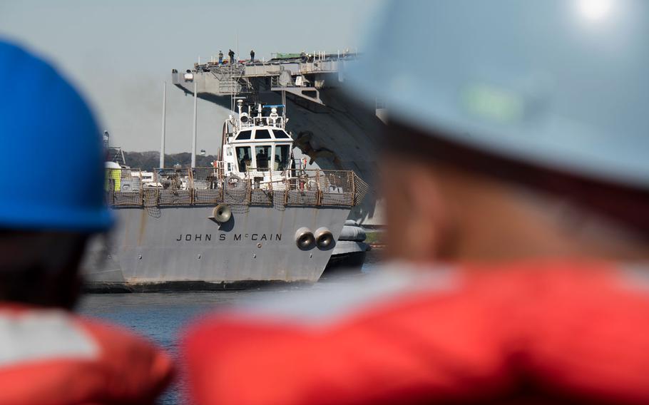 The guided-missile destroyer USS John S. McCain is towed to the pier at Yokosuka Naval Base, Japan, the vessel's homeport.