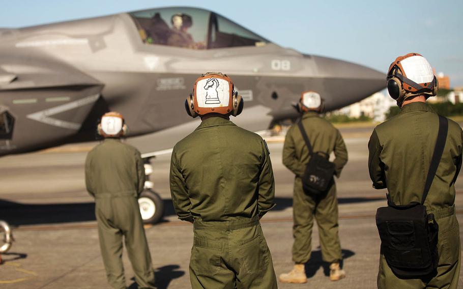 Marines stand by while an F-35B Lightning II jet refuels at Marine Corps Air Station Futenma, Okinawa, Tuesday, Nov. 27, 2018.