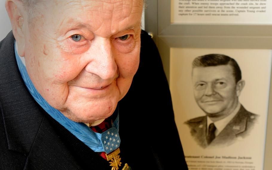 Retired Air Force Col. Joe Jackson poses with a permanent Medal of Honor display in the Pentagon, which depicts him and other medal recipients, on March. 24, 2015. Jackson died over the weekend at the age of 95.