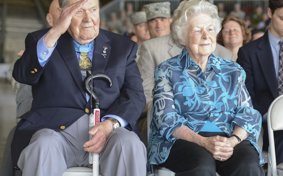 Medal of Honor recipient, retired Col. Joe M. Jackson, joined by his wife Rose, returns a salute to Col. Wyn Elder, outgoing 62nd Airlift Wing commander, during a ceremony on July 17, 2013, at Joint Base Lewis-McChord, Wash. Jackson earned the Medal of Honor in 1968 for his heroic aerial evacuation of a team of pinned-down combat controllers at an overrun airfield in South Vietnam. Jackson died over the weekend at the age of 95.