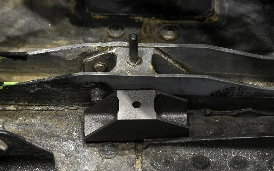 A new metallic 3D printed part sits alongside the aluminum part it will replace inside the cockpit of an F-22 fighter jet during depot repair at Hill Air Force Base, Utah. 