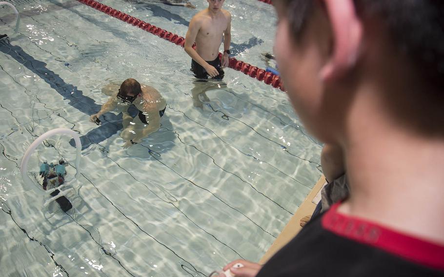 Eden Burton, a seventh-grader at Yokosuka Middle School, drives his team's remotely operated underwater vehicle during a robotics challenge at Yokosuka Naval Base, Friday, Feb. 21, 2020.