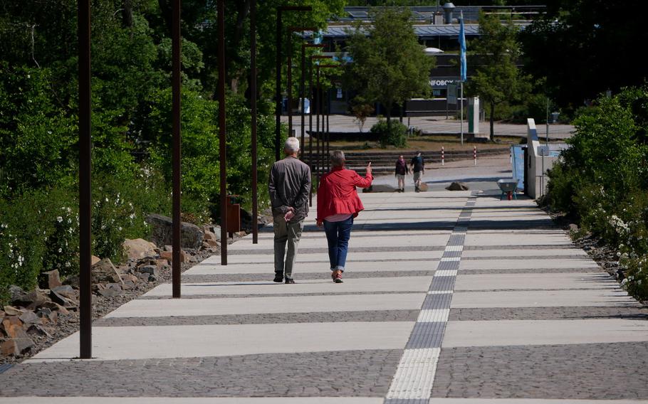 Tourists walk away from the Lorelei along the new path on top of the rock. In the background is the Lorelei visitors center.