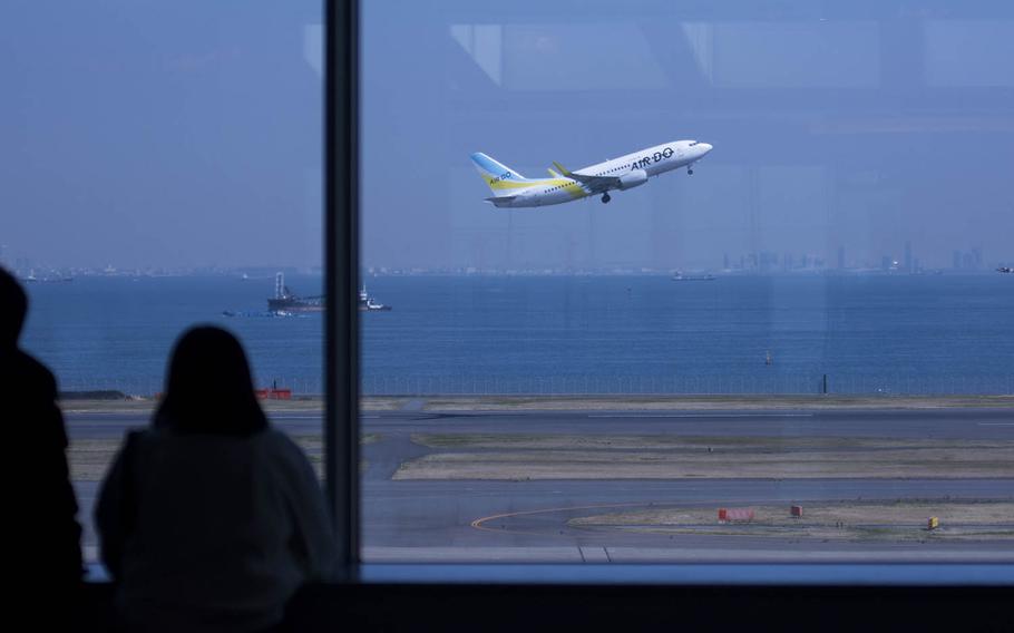 A flight takes off from Haneda International Airport in central Tokyo, March 18, 2020. Akifumi Ishikawa/Stars and Stripes