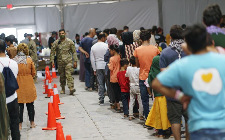 Afghan refugees line up for food in a dining hall at Fort Bliss’ Doña Ana Village, in New Mexico, where they are being housed, Friday, Sept. 10, 2021. 