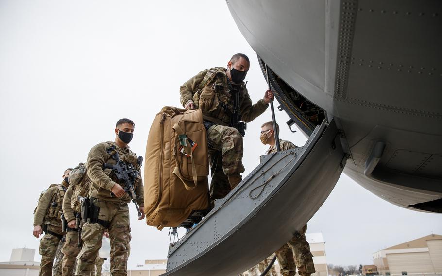 Members of the Illinois Air National Guard's 182nd Airlift Wing security forces board a C-130 Hercules before deploying to Washington D.C., to provide security ahead of President-elect Joseph Biden's inauguration Thursday, Jan. 14, 2021, in Peoria, Ill.