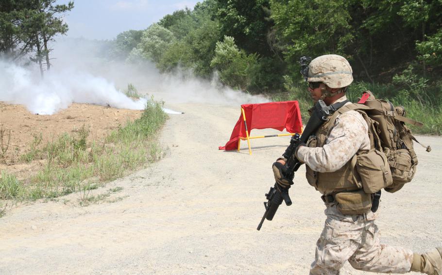 A Marine runs towards his assault position under the cover of smoke during a battalion-wide exercise coordinated with Korean-based U.S. Army units June 9 at the Rodriguez Live Fire Complex near the Demilitarized Zone. The complex exercise marked the final stage of the Unit Deployment Program for the Camp Lejeune-based Marines from 3rd Battalion, 2nd Marine Regiment. 

