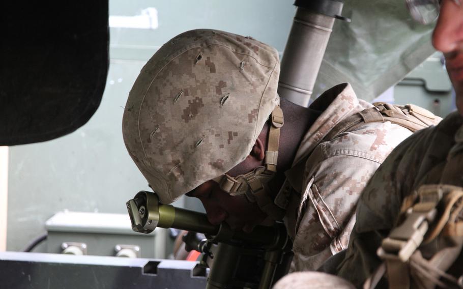 Lance Cpl. Trevon Nottage catches a few winks while holding his mortar tube in the back of a 7-ton transport vehicle June 9, 2015, while waiting for a battalion-wide exercise to commence in South Korea.