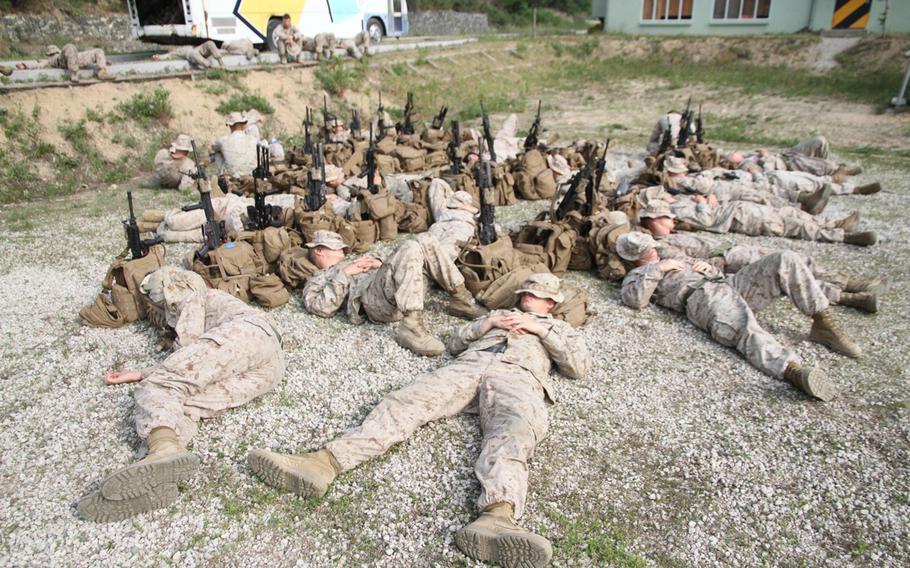 Marines can sleep anywhere. Here, they catch a few winks while waiting for a battalion-wide exercise to commence.