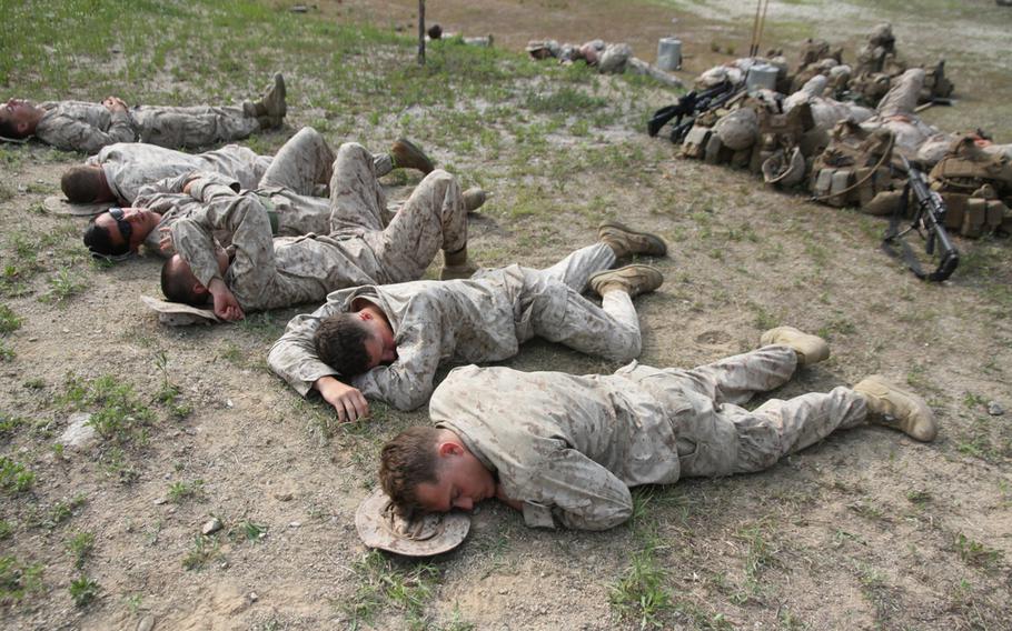 Marines sleep on the hard ground while waiting several hours for a battalion-wide exercise to commence in South Korea.