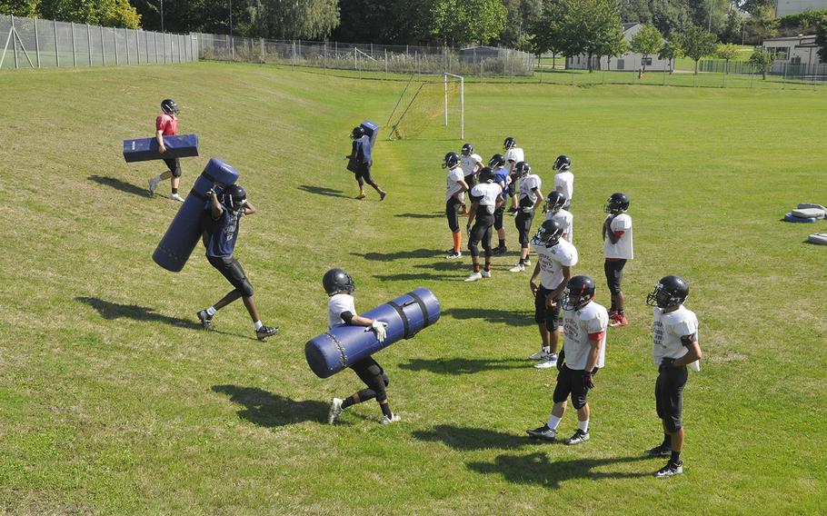Spangdahlem Sentinels football players carry pads up and down a steep hill during a preseason practice Thursday, Aug. 22, 2019, at Spangdahlem Air Base. Where the team's practices were more specialized by position during the program's 11-man era, the smaller Sentinel roster is running more team-wide drills to prepare for the six-man game. 