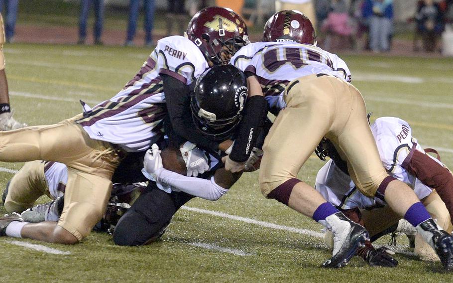 Zama's Keshawn McNeill gets snowed under by Matthew C. Perry defenders.