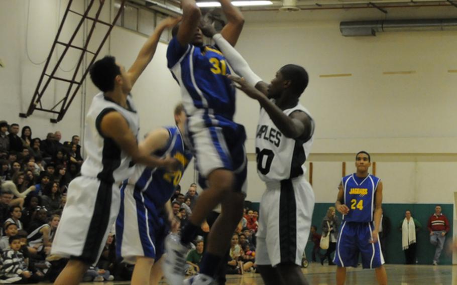 Sigonella's Christian McKissick is surrounded by Naples defenders Friday during the Wildcats' 72-39 victory that clinched the American Schools in Italy crown for Naples.