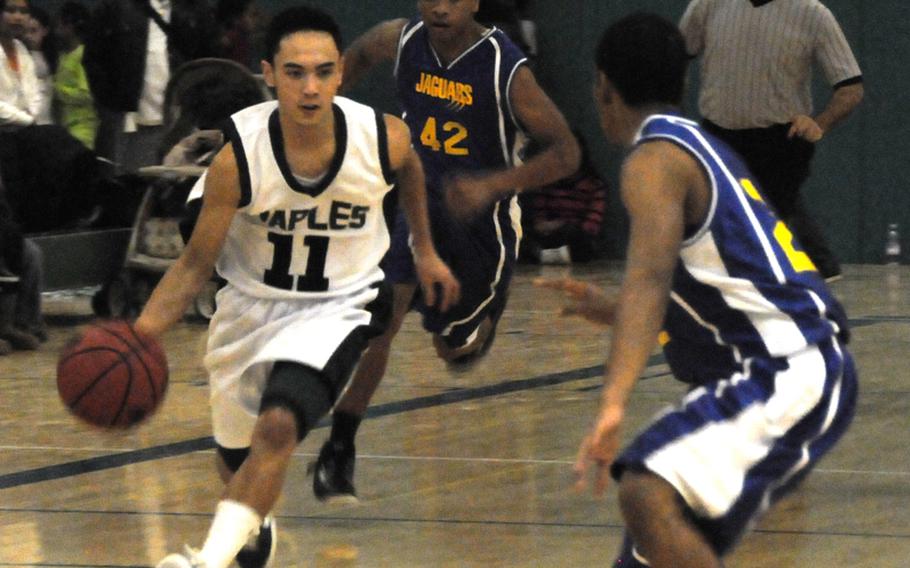 Naples point guard Jun Jun Gallardo pushes the ball up court in the Wildcats' 72-39 victory Friday over Sigonella, a win that clinched the regular-season American Schools in Italy championship for Naples.