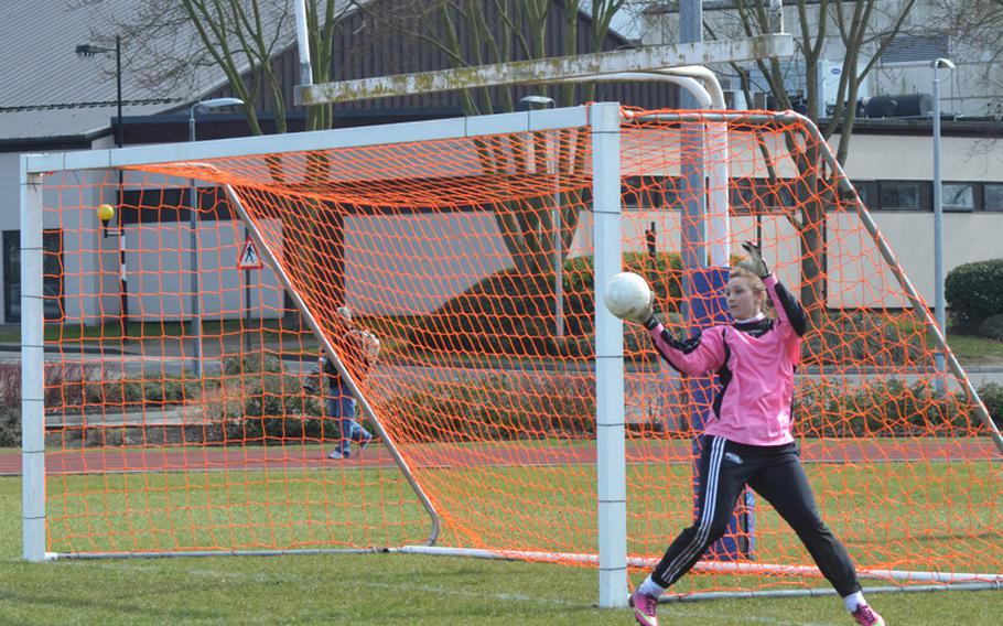 Kate Turner, goalie for Menwith Hill girls soccer team, catches the ball as it goes wide of the netl during a game at Lakenheath on Saturday. Menwith Hill didn't have enough players and had to forfeit 1-0.