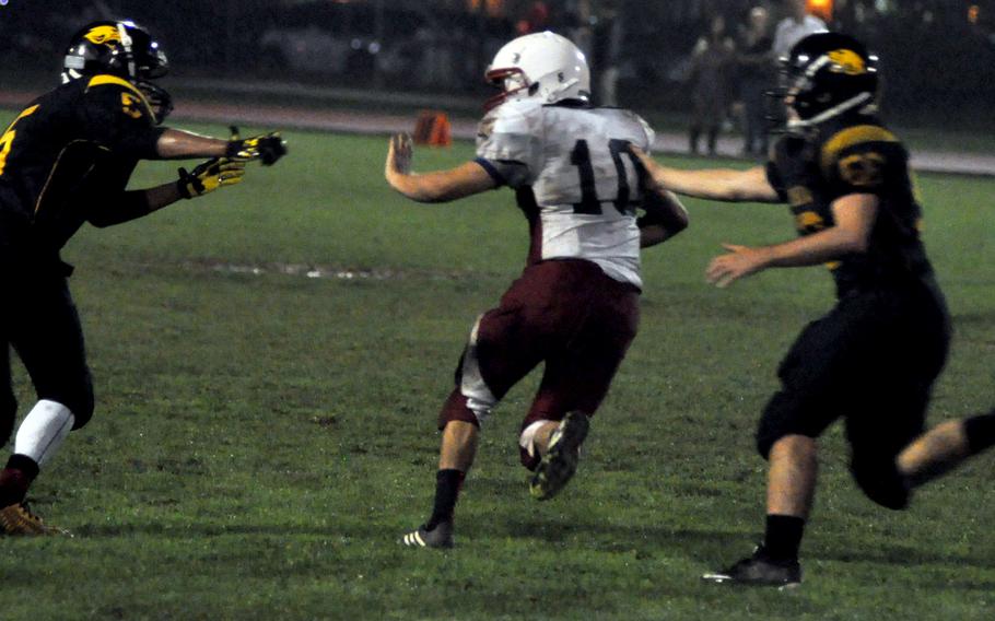 ISB's Patrick Clifford breaks free from a pair of Vicenza defenders for a 20-yard gain Friday night in the Cougars 35-0 victory over the Raiders.

Kent Harris/Stars and Stripes