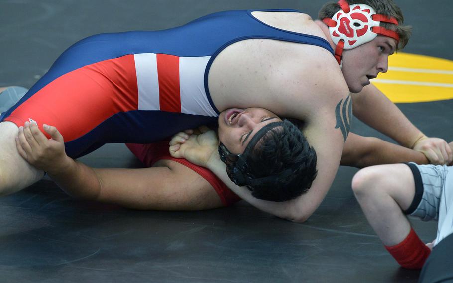 Lakenheath's Casey Fairchild, top, puts the pressure on Aviano's Joseph Rivera in a 285-pound match on opening day of the DODDS-Europe wrestling championships in Wiesbaden, Germany, Friday, Feb. 13, 2015. Fairchild won the match.