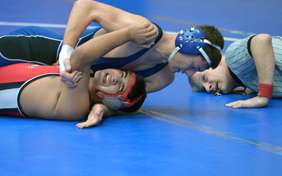 Kaiserslautern's Dante Rincon, bottom, struggles to get out of the grip of Rota's Thomas Jordan in a 152-pound match on opening day of the DODDS-Europe wrestling championships in Wiesbaden, Germany, Friday, Feb. 13, 2015. Jordan won the match.