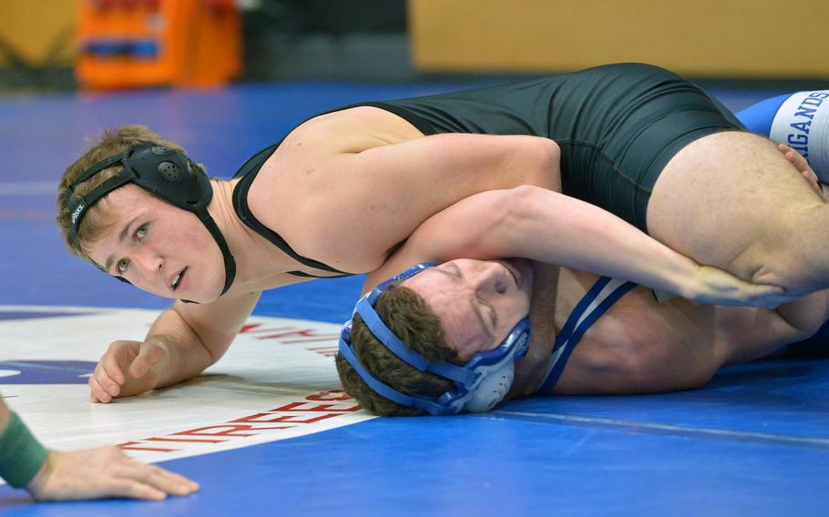 Vicenza's Canaan York, top, looks to the referee for a decision in his 145-pound weight class win against Canyon LaClair of Brussels on opening day of the DODDS-Europe wrestling championships in Wiesbaden, Germany, Friday, Feb. 13, 2015. 