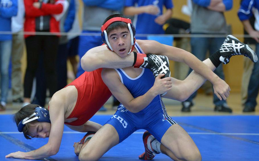 Stanley Cruz of Ramstein looks at his coach as he wrestles Aviano's Kyle Kochan in a 120-pound bout on opening day of the DODDS-Europe wrestling championships in Wiesbaden, Germany, Friday, Feb. 13, 2015. Cruz won the match.