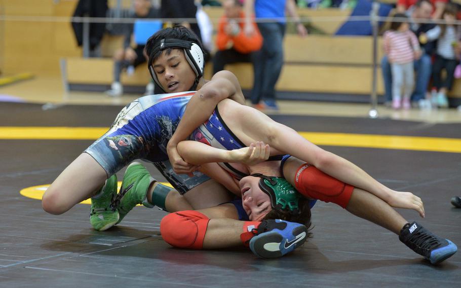 Bitburg's Kurt Nacionales, top, wraps up Seamus Wade of Naples in a 113-pound match on opening day of the DODDS-Europe wrestling championships in Wiesbaden, Germany, Friday, Feb. 13, 2015. Nacionales won the match.