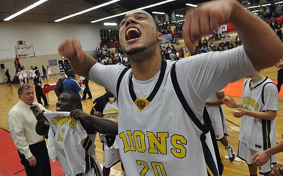 Heidelberg's Chris Cuthbert, right, and Eugene Jones show their fans Lion pride after defeating Ramstein, 73-51, in the Division I title game at the DODDS Europe basketball championships in Mannheim, on Saturday night.