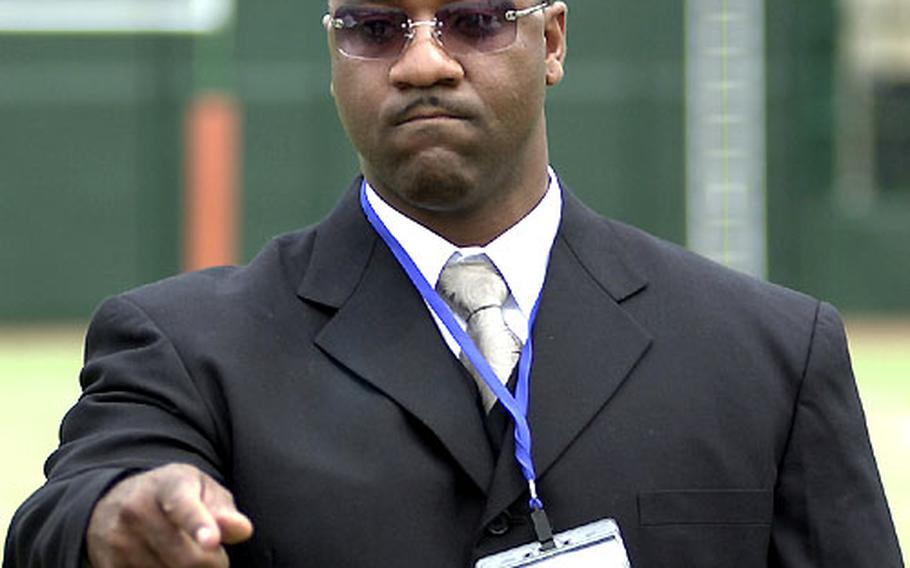 Joseph Howell, commissioner of the U.S. Forces Japan-American Football League, tosses the coin before Sunday&#39;s game.