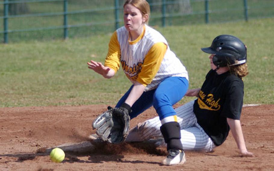 Hanau&#39;s Chassity Pellegrino, right, slides safely after stealing third as Wiesbaden&#39;s Melissa Mueller fields the throw during a DODDS softball game in Wiesbaden, Germany, on Saturday.