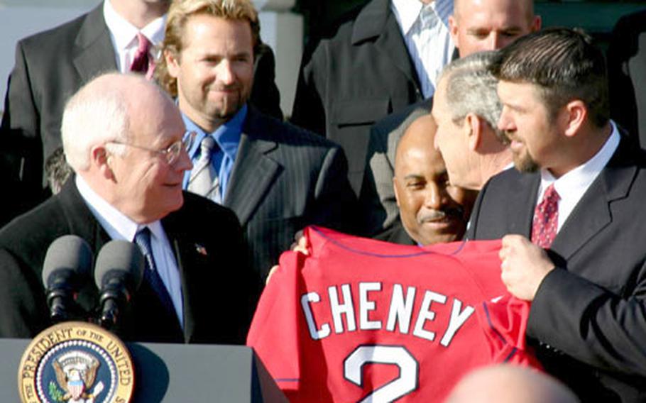 Red Sox catcher Jason Varitek presents Vice President Cheney with a Red Sox jersey during Wednesday&#39;s ceremony at the White House.
