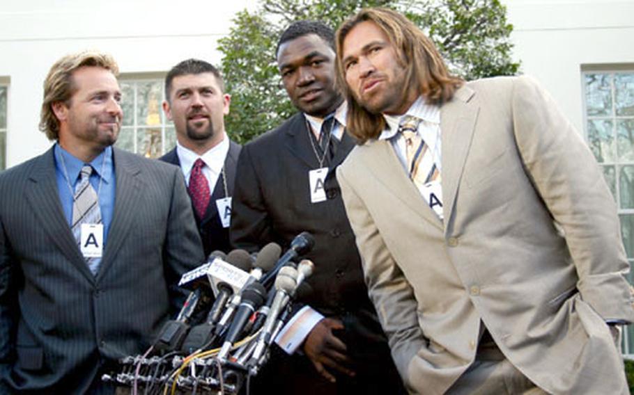 Well-dressed Red Sox players Kevin Millar, Jason Varitek, David Ortiz and Johnny Damon meet the press after Wednesday&#39;s ceremony at the White House.