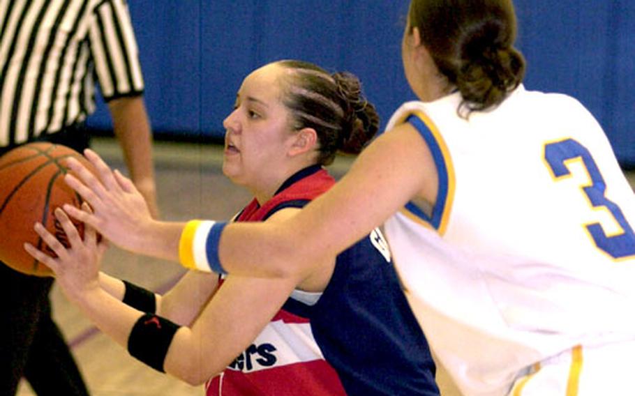 Jessica Garcia, left, of Korea&#39;s Osan Defenders passes off as Stacy Hopwood (3) of Korea&#39;s Kunsan Wolf Pack defends during Tuesday&#39;s round-robin play in the 2005 March Madness Open Basketball Tournament at the Coral Reef Fitness and Sports Complex, Andersen Air Force Base, Guam. Osan won 68-59.