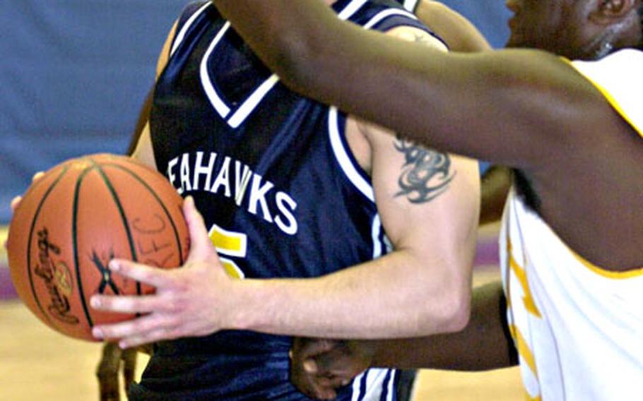 Nate Burnett (25) of the Yokosuka Seahawks drives to the basket on Joshua Jones (30) of USS Frank Cable during Friday&#39;s double-elimination playoff game.
