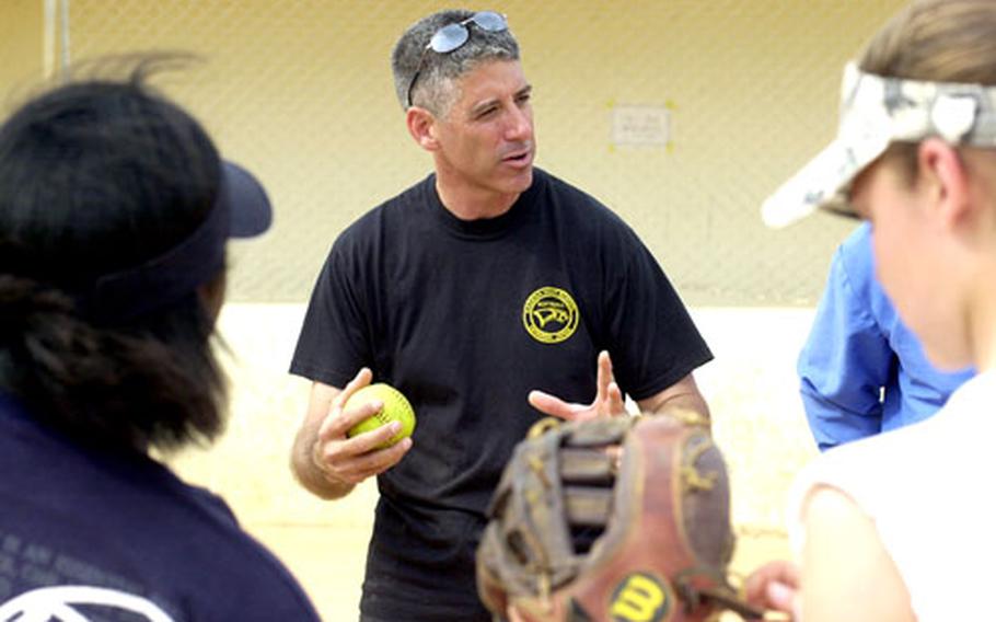 Assistant coach Tony Davis talks to Kadena softball players on Tuesday.
