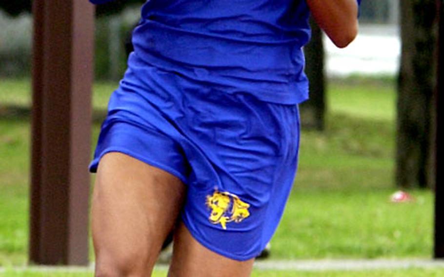 Yokota freshman sprinter Charlotte Taylor prepares to hand off the baton in the first leg of the 400-meter relay. Yokota won in 49.8 seconds, breaking its own league record of 50.6.