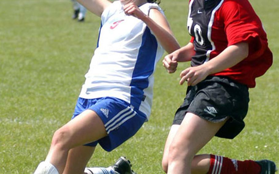 Ramstein&#39;s Susie Fluker, left, and Kaiserslautern&#39;s Abby Haplin fight for a ball in a Division I semifinal at Ramstein on Thursday. Ramstein beat cross-town rival Kaiserslautern 1-0 to advance to Friday&#39;s Division I final.