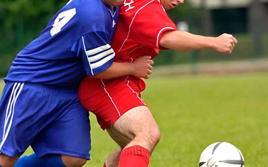 Rota&#39;s Joey Beidelman, left, and American Overseas School of Rome&#39;s Giulio Caperchi battle for the ball during the DODDS European Division III high school boys soccer championship game in Ramstein, Germany, on Saturday. AOSR defeated Rota 3-0 to win the division title.