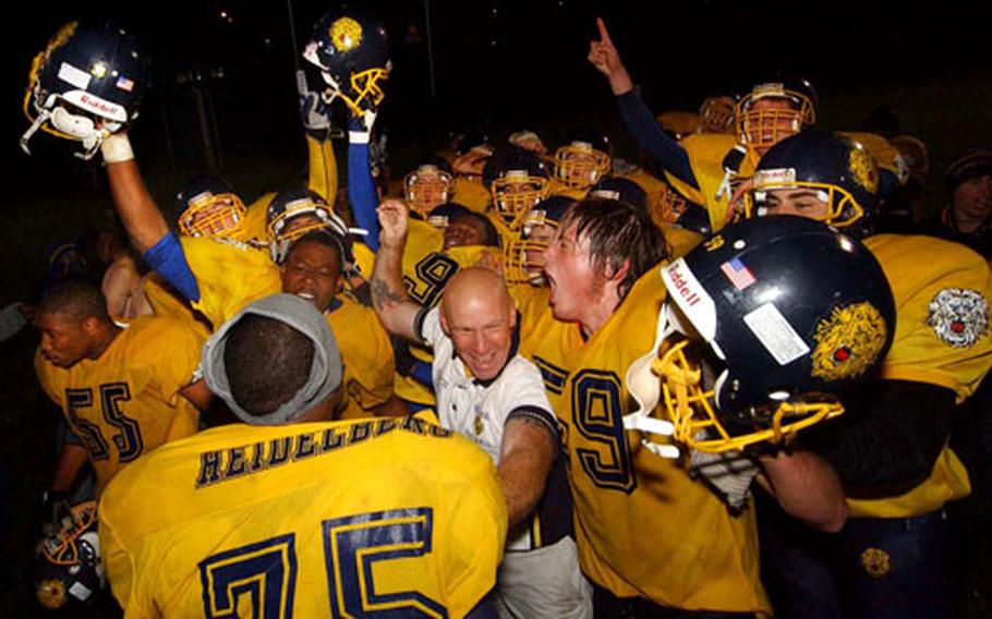 Heidelberg players and assistant coach Sal Katz Jr. celebrate beating Ramstein to win the Division I crown.