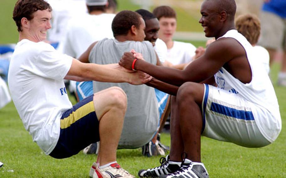 Ansbach&#39;s David Zumbach, left, and Xavier Sheppard warm up for the afternoon session of the DODDS European Football Camp at Ansbach High School, Germany.