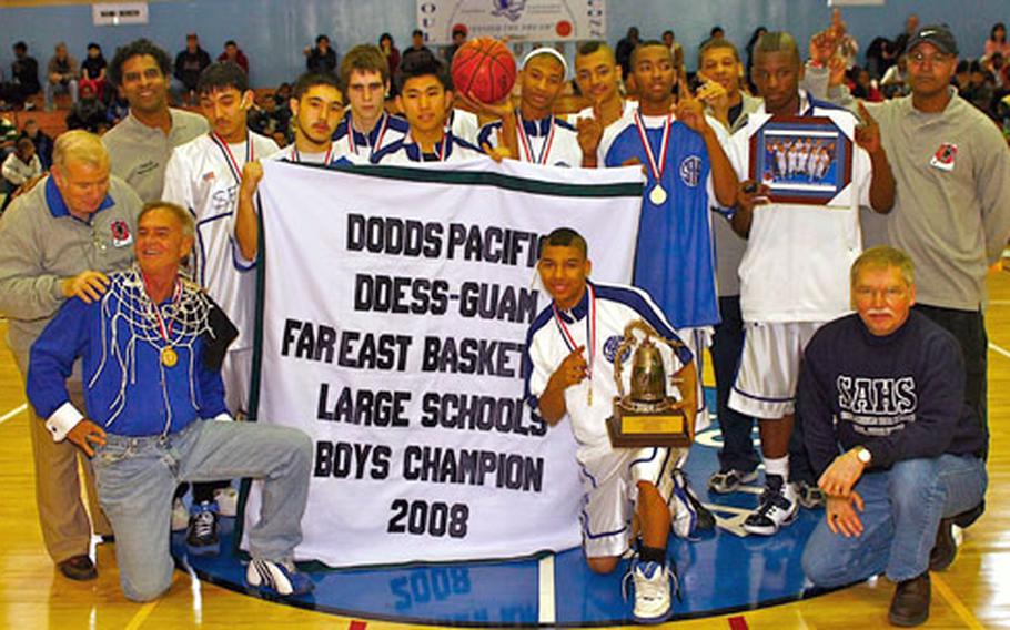 Seoul American Falcons coaches, players and administration celebrate with the banner and first-place trophy after Saturday&#39;s championship game in the 2008 DODDS-Pacific Far East High School Boys Class AA (large schools) Basketball Tournament at Falcon Gym, Seoul American High School, South Post, Yongsan Garrison, South Korea.