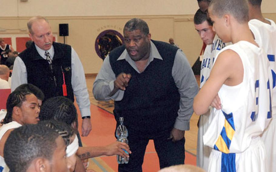 Bamberg (Germany) High School boys&#39; basketball coach Charles E. "Chuck" Jordan, center, talks to his team during a timeout in last year&#39;s Division IV final against Menwith Hill. Jordan died following complication from surgery.