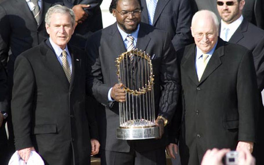 U.S. President George W. Bush (L) accepts a jersey from Boston Red Sox team captain  Jason Varitek (L) as Bush honored the 2007 World Series Champions, the  Boston Red Sox, on the