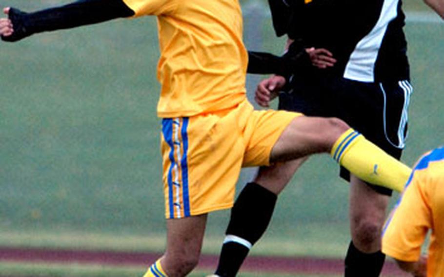 Peru Nikei club team striker Everton and Kadena Panthers sweeper Aaron Ahern go up to head the ball during Saturday&#39;s soccer match at Camp Foster, Okinawa. Peru Nikei, an adult club team of South American and Japanese players, shut out Kadena. 2-0.