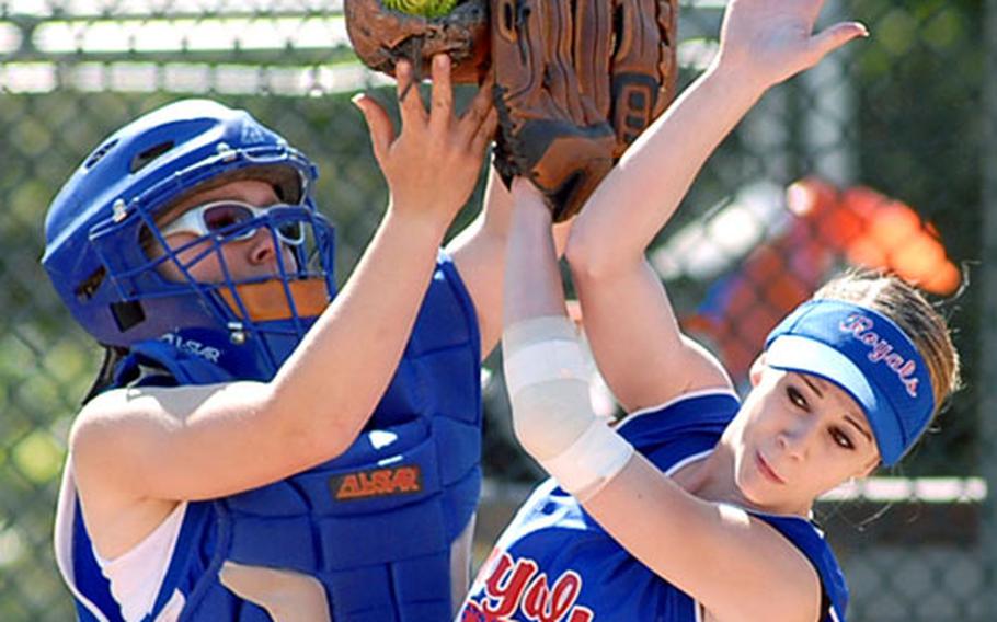 Ramstein catcher Becky Pletzer and pitcher Lindsey Jones collide going after a foul ball in the first game of a doubleheader against Lakenheath on Saturday. Pletzer held onto the ball, and Ramstein went onto win the close game 10-8.